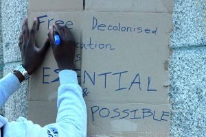 Preparing a placard for Pathways pamphlet distribution at parliament.